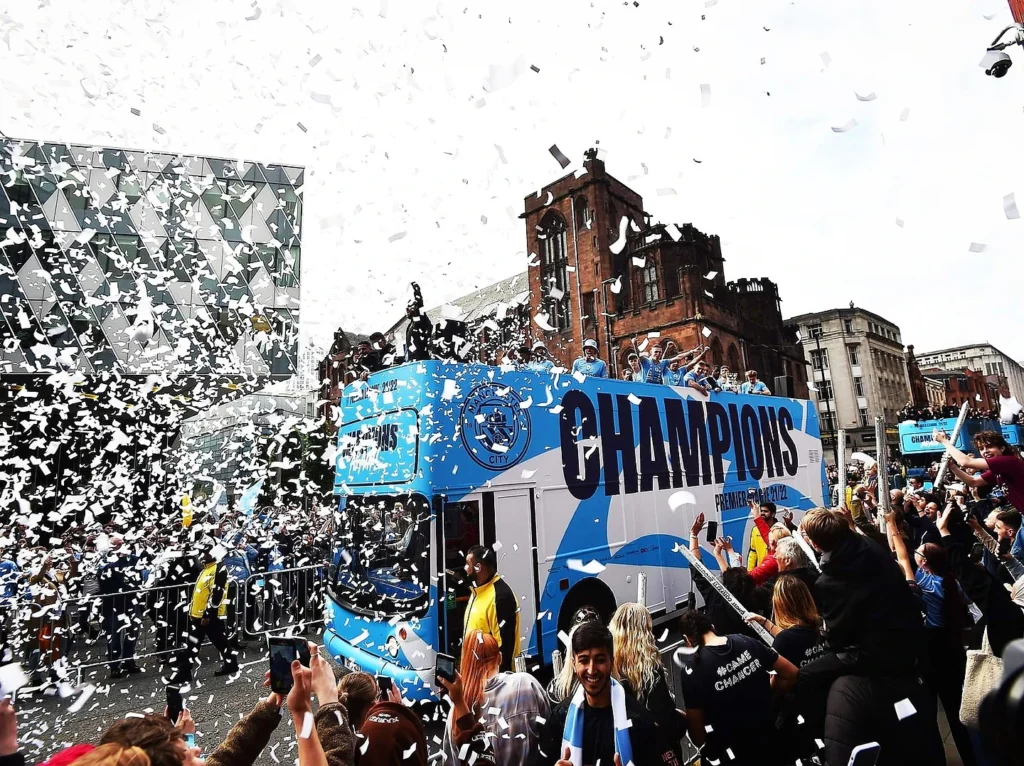 A vibrant celebration at the champions parade with confetti and fans cheering.