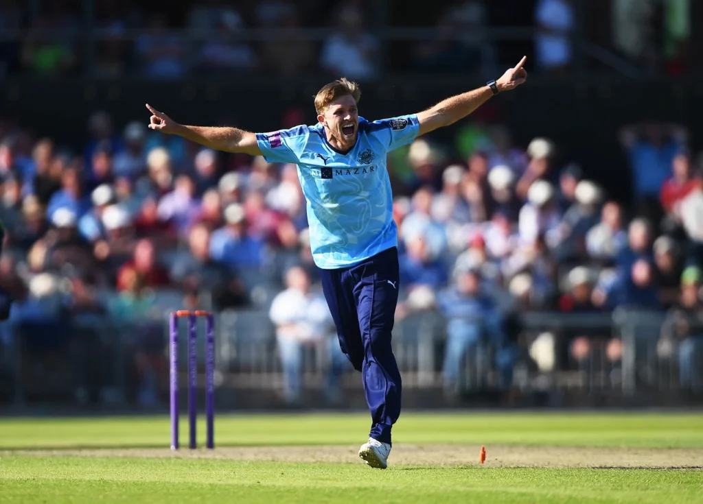 A cricket player celebrating a wicket during a match.