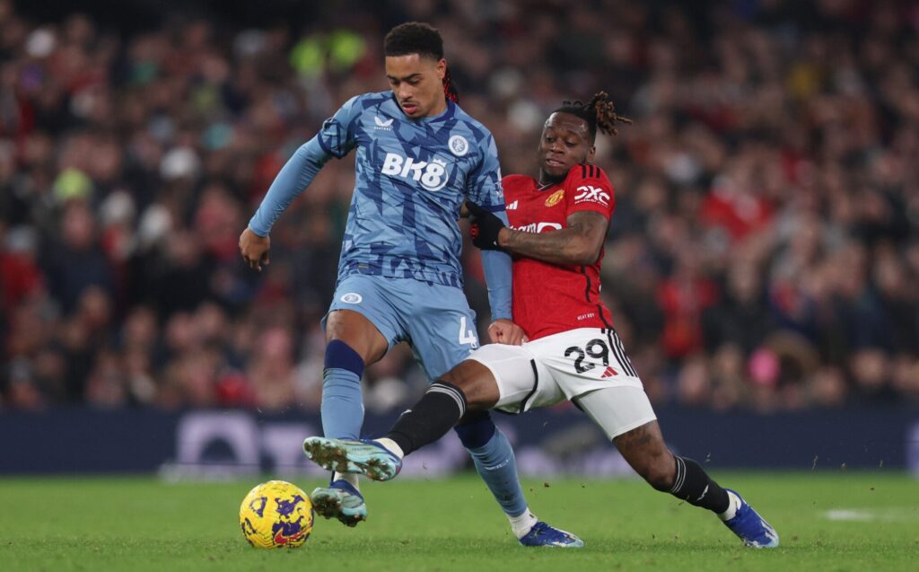 Action shot of Chelsea and Manchester United players competing for the ball during a football match.