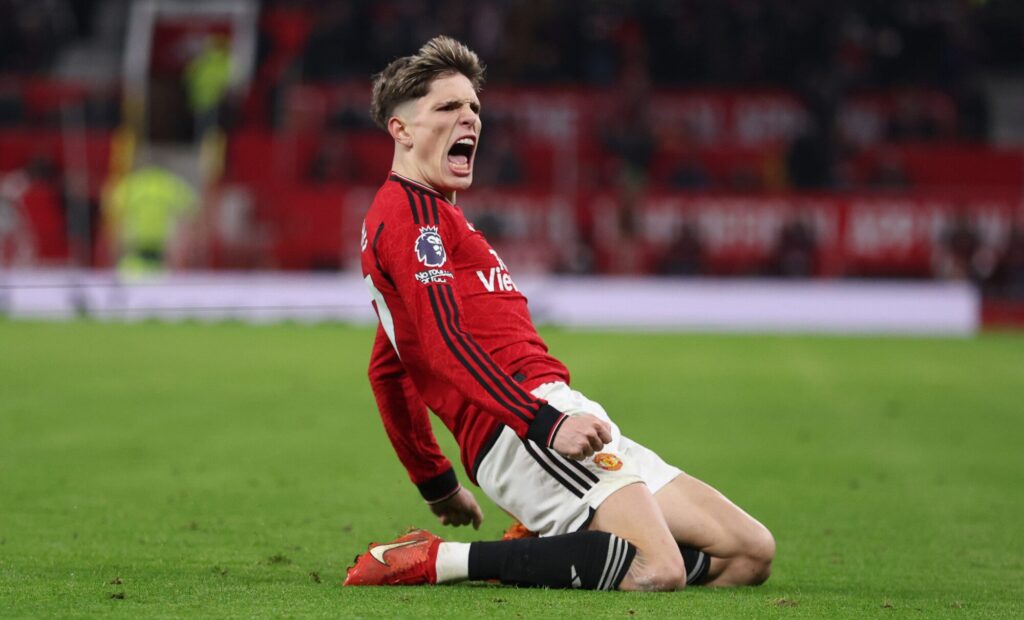 Manchester United player celebrating a goal on the pitch.