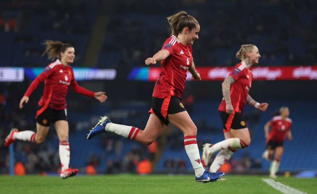 Manchester United women's team celebrating a goal during a match.