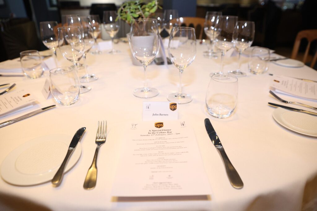 A table set for a special dinner event, showcasing elegant glassware and utensils.