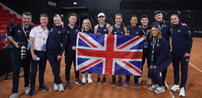 British tennis team posing for a group photo with the national flag.