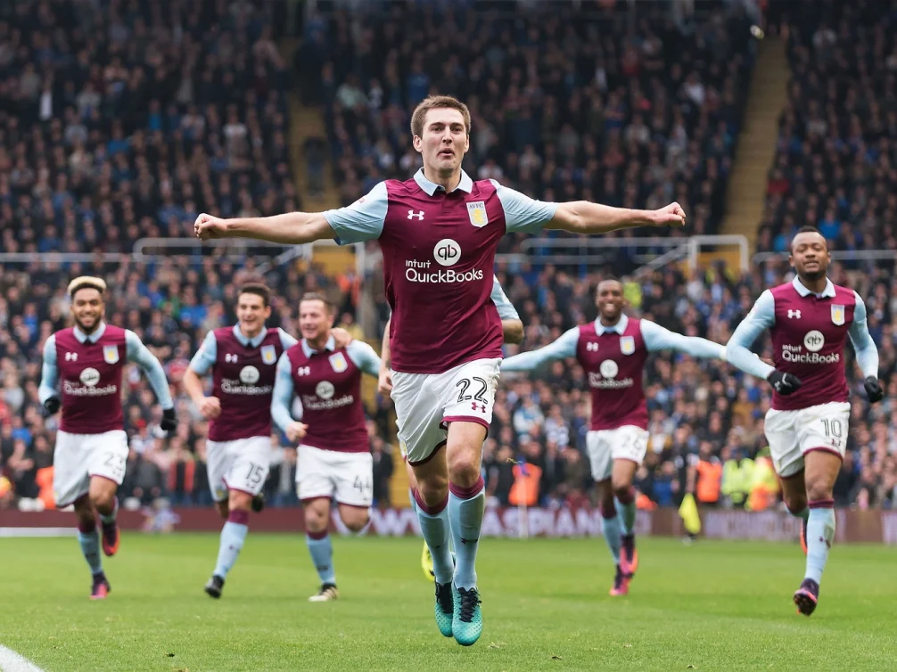Aston Villa players celebrating a goal during a match.
