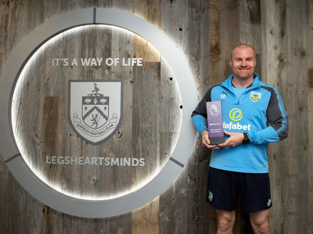 Burnley Football Club manager holding the Barclays Manager of the Month award.