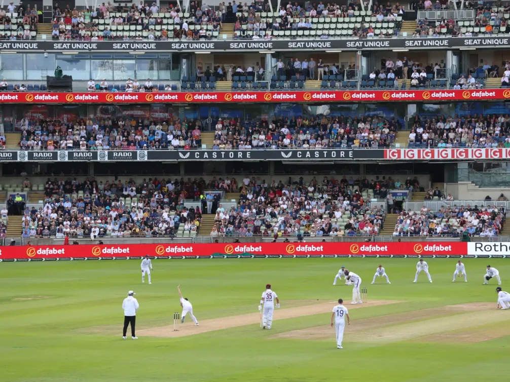 A cricket match in Birmingham with players on the field and a large crowd in the stands.