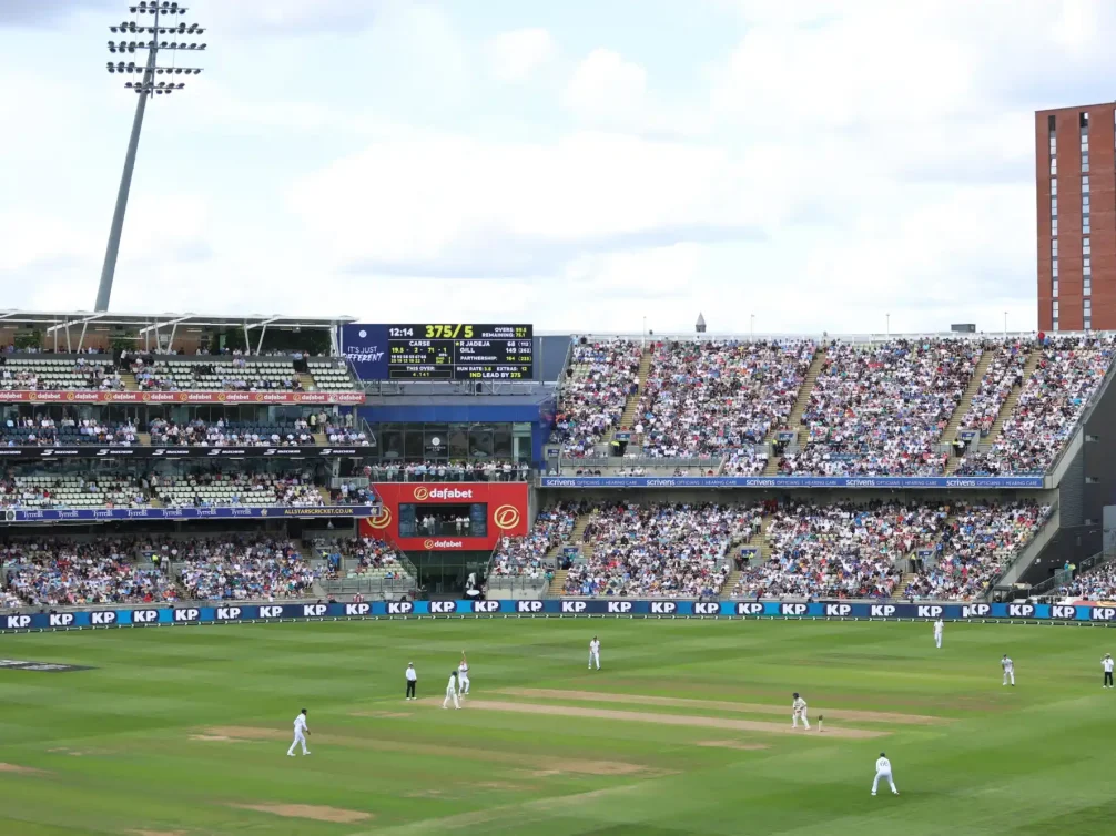 Live cricket action captured during a match in Birmingham, showcasing players and fans.