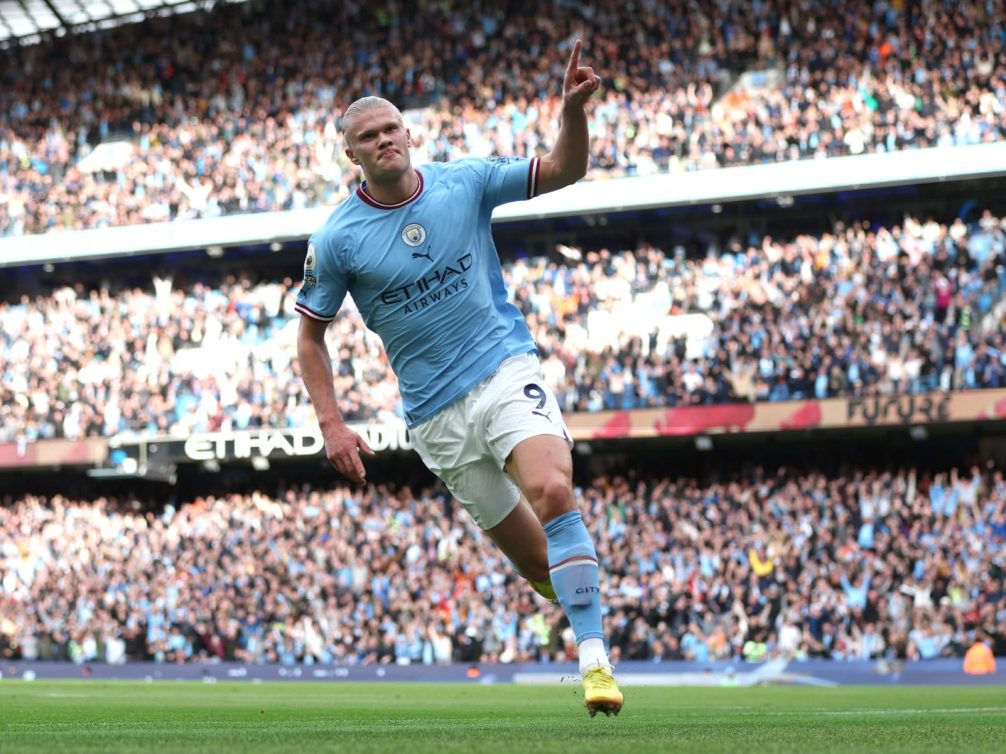 Manchester City player celebrating a goal at the Etihad Stadium.