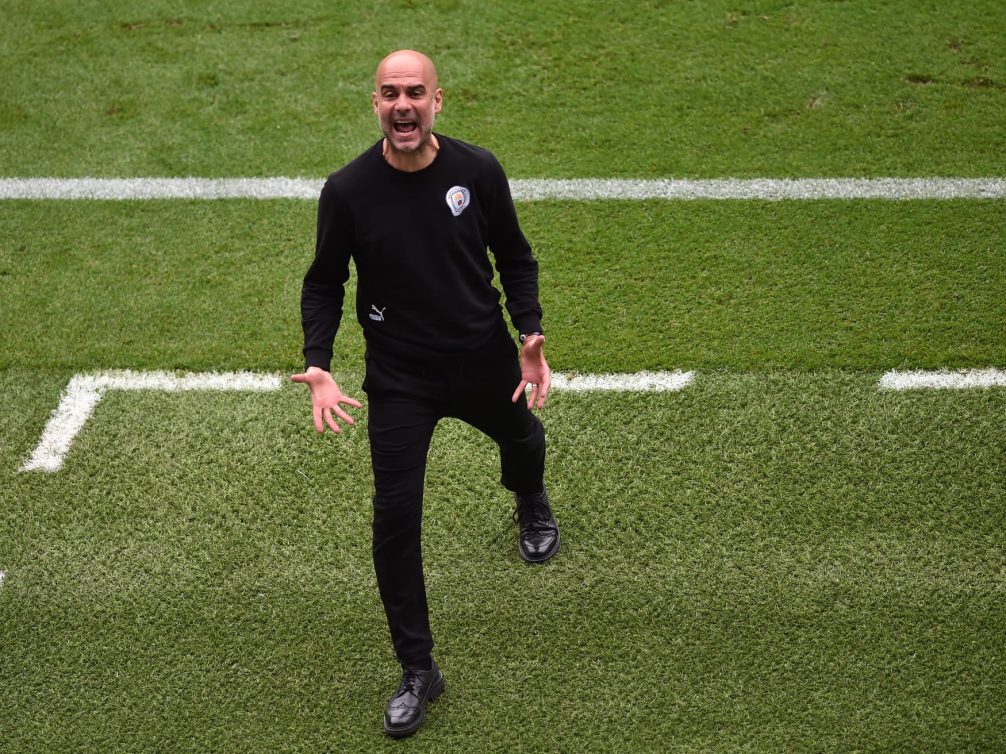 Pep Guardiola passionately coaching during a football match.