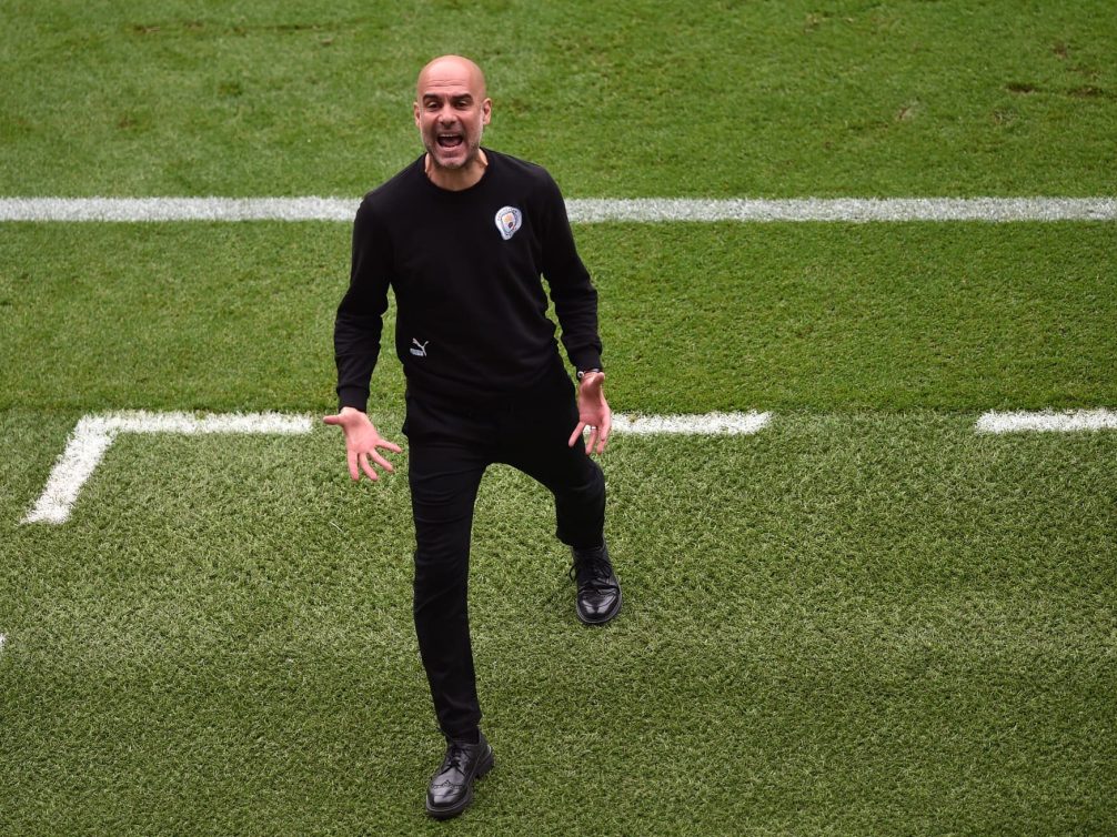 Pep Guardiola passionately coaching during a football match.