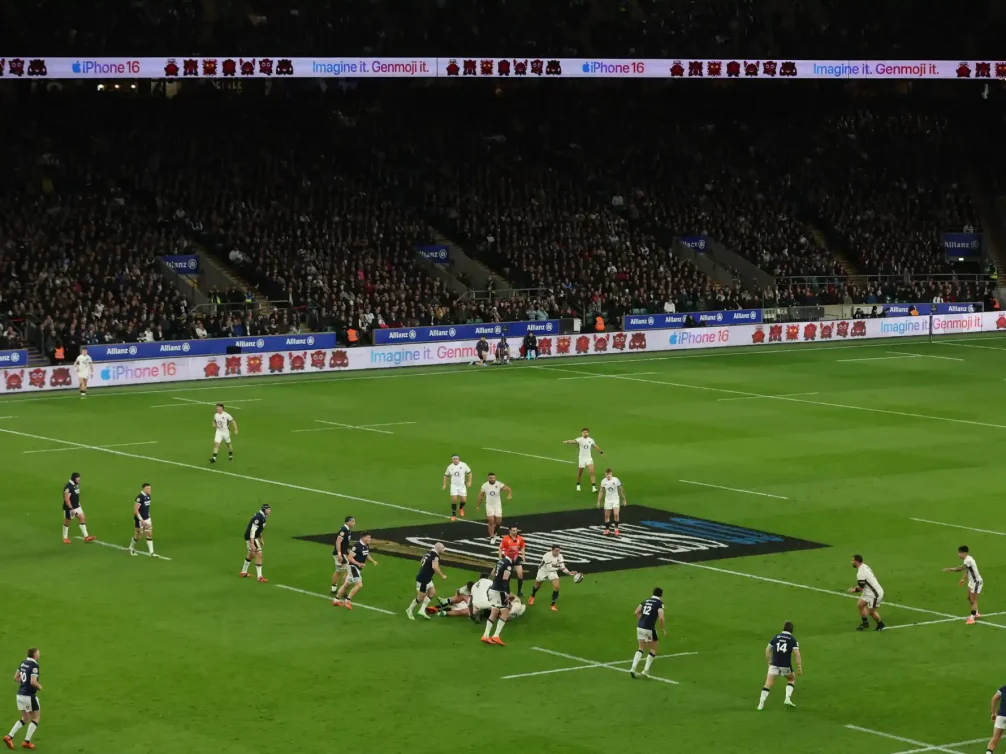 Rugby players competing for the ball on the field.
