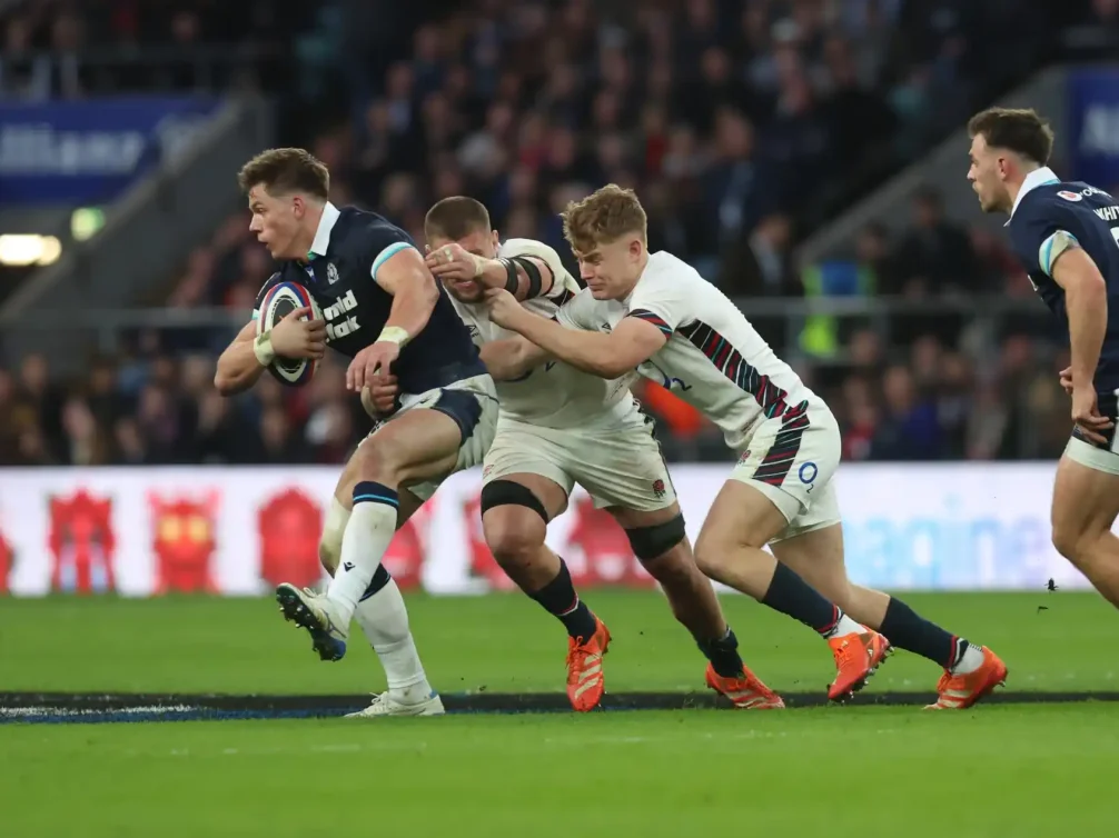 England players tackling a Scotland player in rugby match