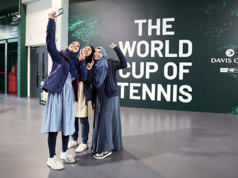 Friends capturing a selfie at the Davis Cup tennis tournament.