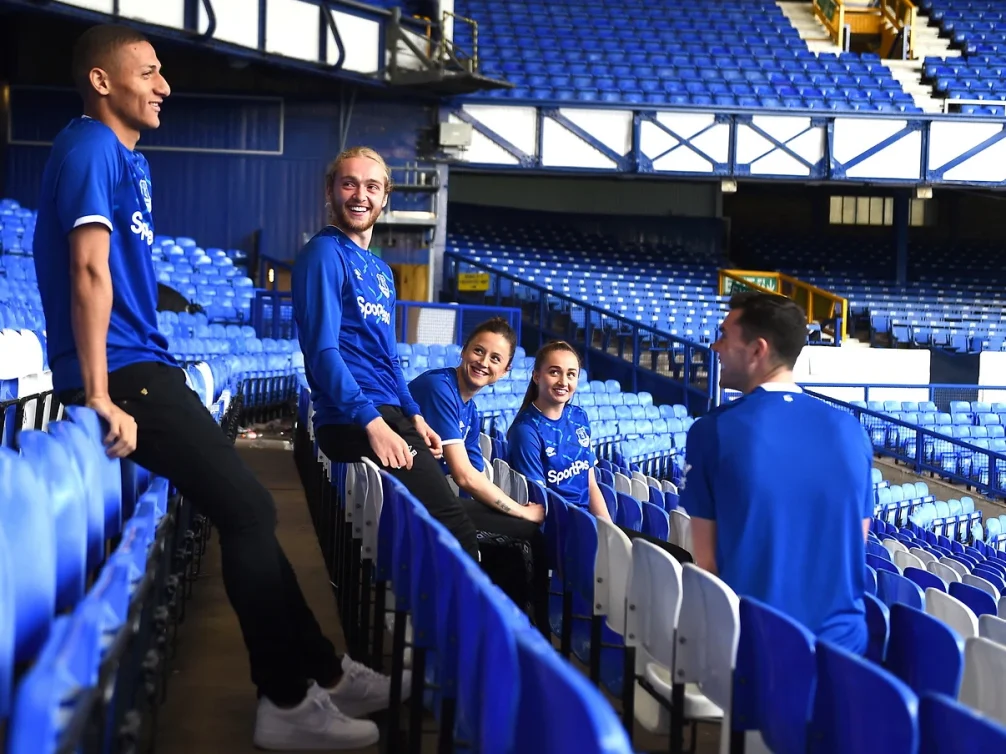 Smiling football players enjoying their time in the stadium.
